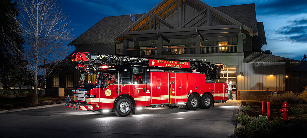 January 2024 Truck Of The Month Pierce Mfg   Banner Velocity Ascendant 107 Aerial Ladder Parked In Front Of Firehouse At Dusk 